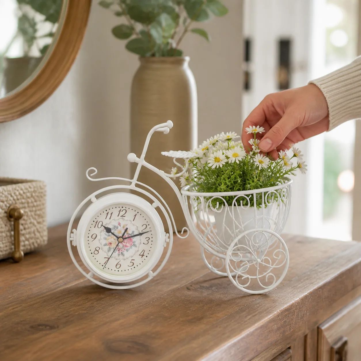 Vintage bicycle planter clock on an entryway console Hand arranging flowers in the planter basket of a vintage bicycle table clock
